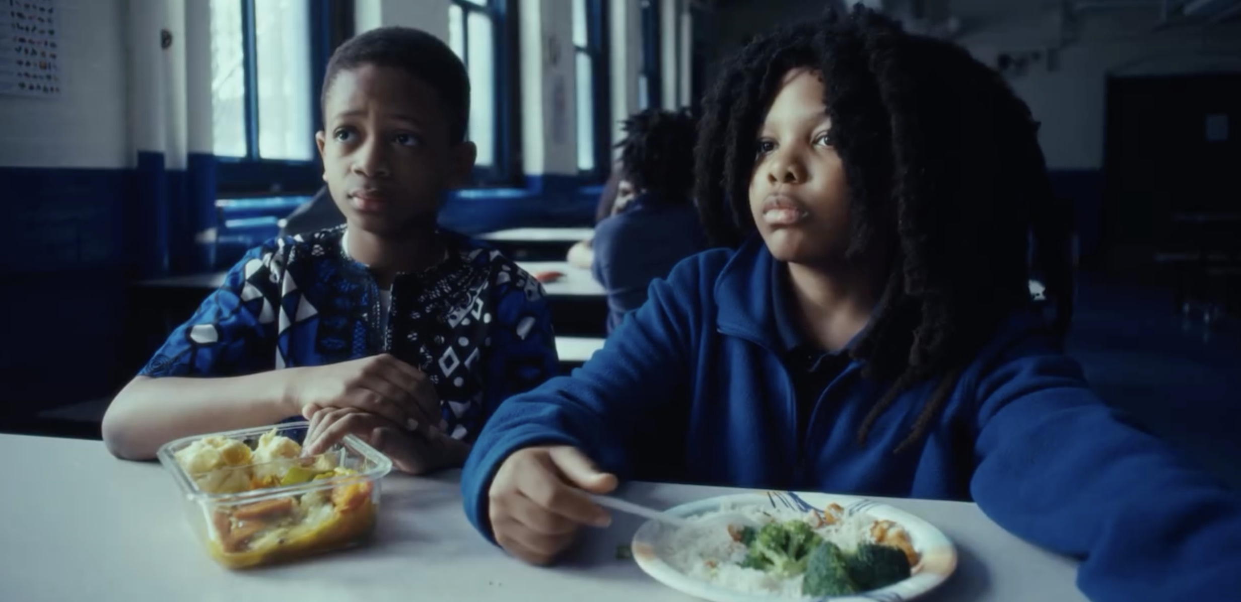 Two young boys eat lunch